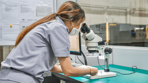 Inquest of tight tolerance: QC technician inspecting the end product