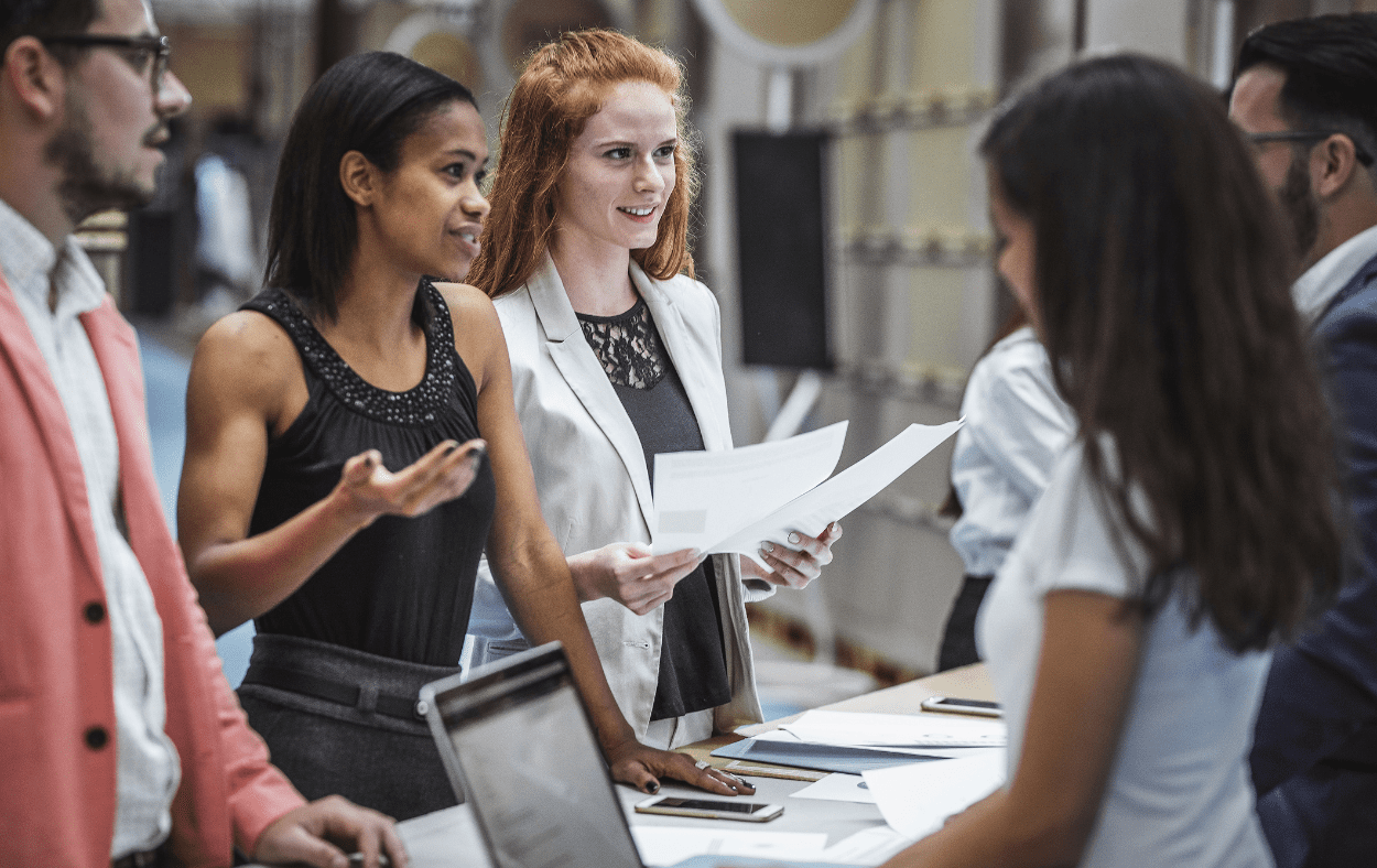 Exhibition attendees conversing with the exhibitors
