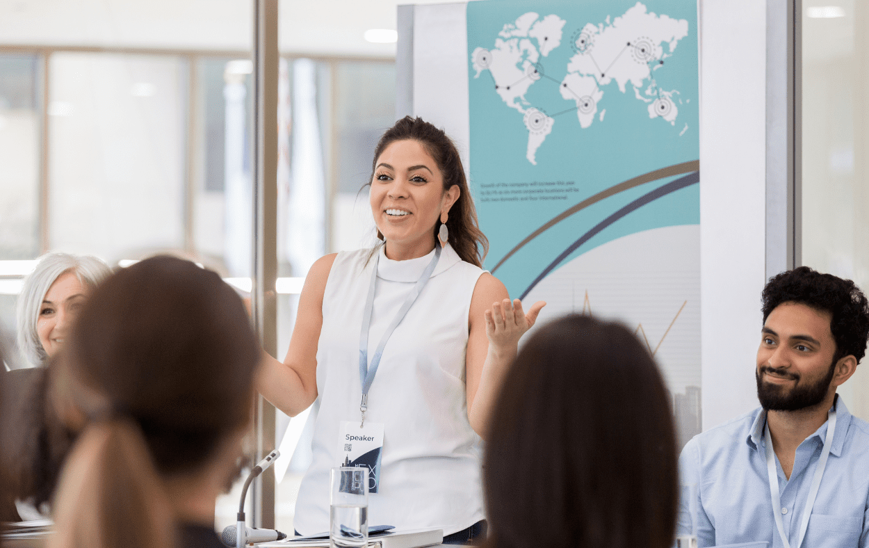 A panel of speakers at an exhibition addressing the audience